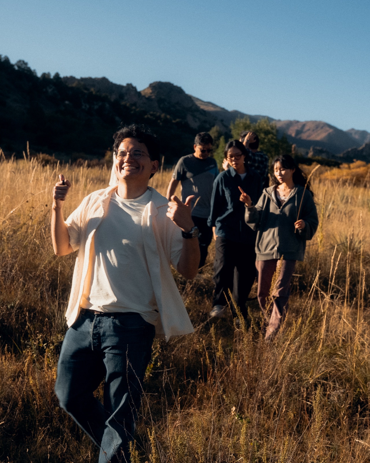 YWAM Château students walking together through tall grass at the Swiss base