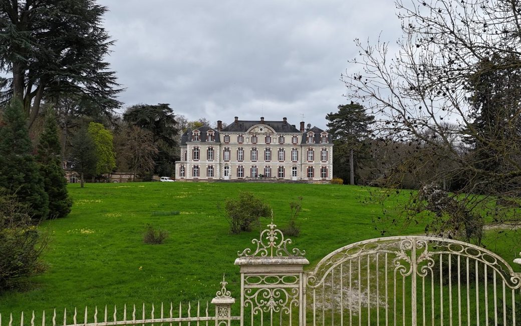 The château in France, seen from its front gate across the lawn